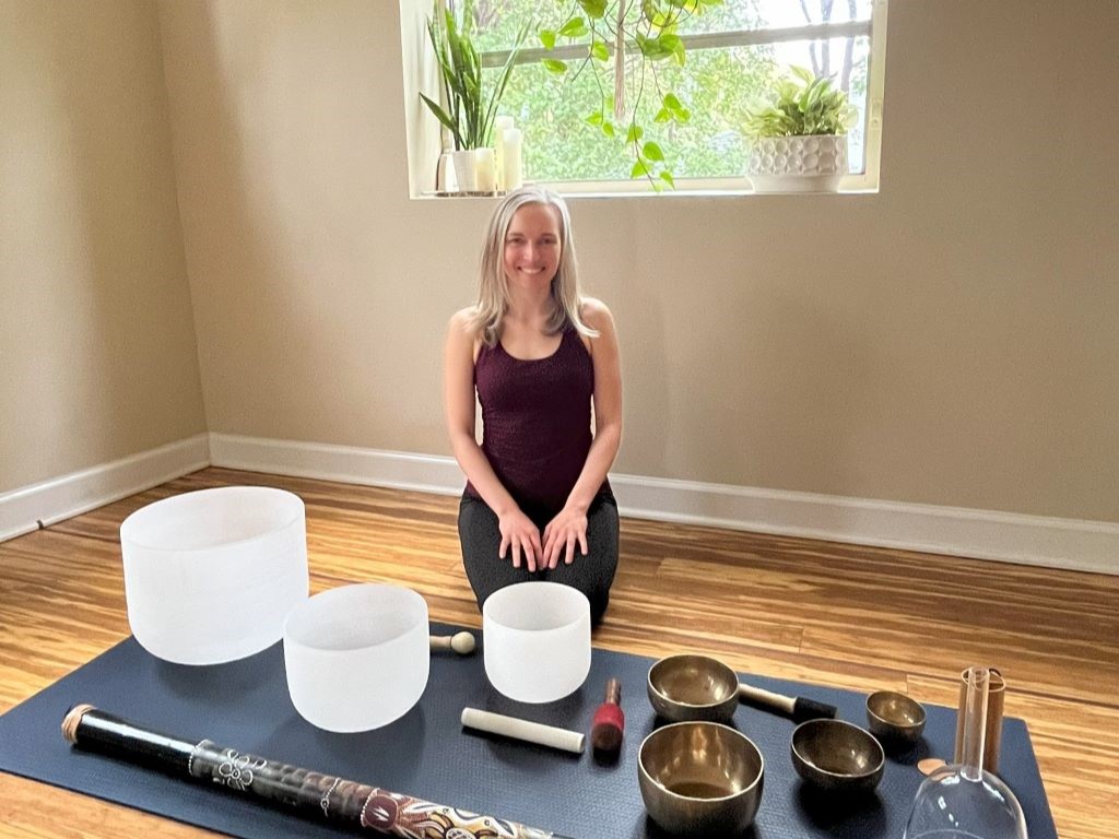 Veda playing a variety of sound healing instruments including bowls and gongs
